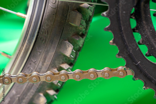 detail of bicycle transmission chain bob green background.