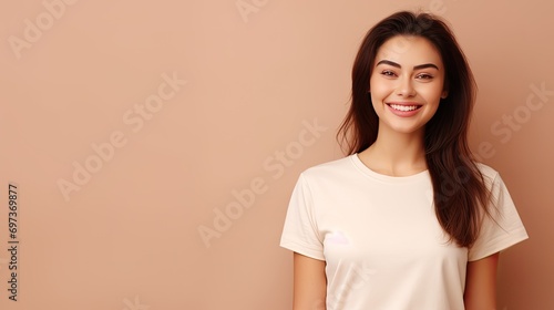Happy young woman wearing white t-shirt on beige background