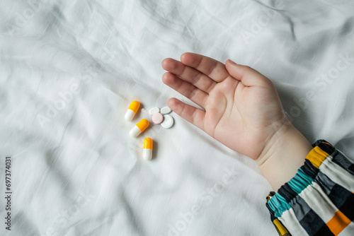 A child s hand is holding a handful of pills and capsules  Generative Ai