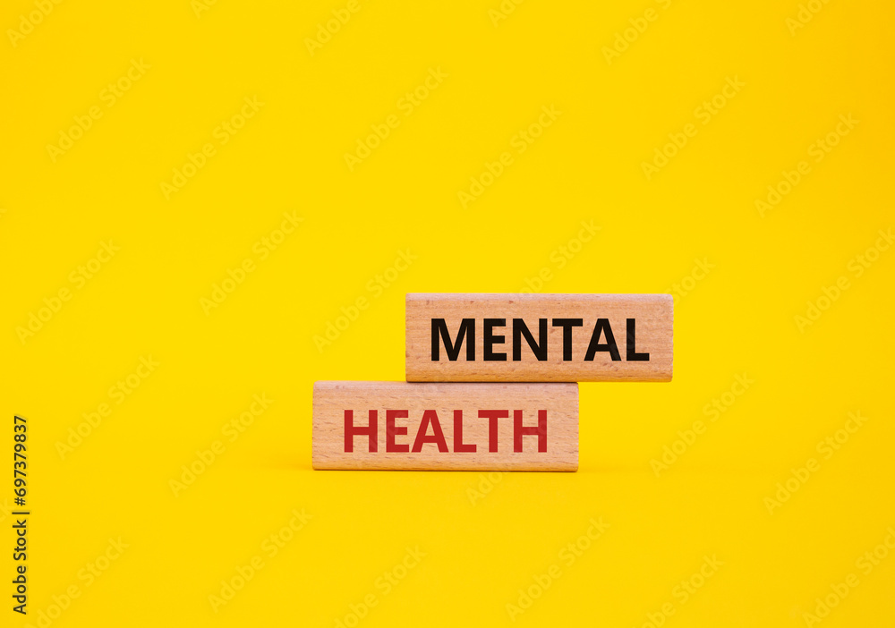 Mental Health symbol. Concept word Mental Health on wooden blocks. Beautiful yellow background. Psychology and Mental Health concept. Copy space - obrazy, fototapety, plakaty 