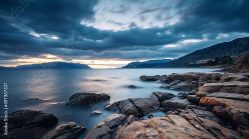 Wallpaper Mural A shot that captures the beauty of a sea and rocky mountain in the distance with clouds in the sky. Torontodigital.ca