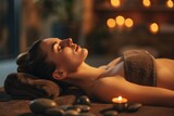 Woman laying on a massage table with candles in the background. Ideal for spa and relaxation concepts