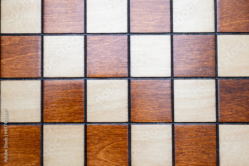 Checkerboard - chessboard detail - top view squares  wooden background