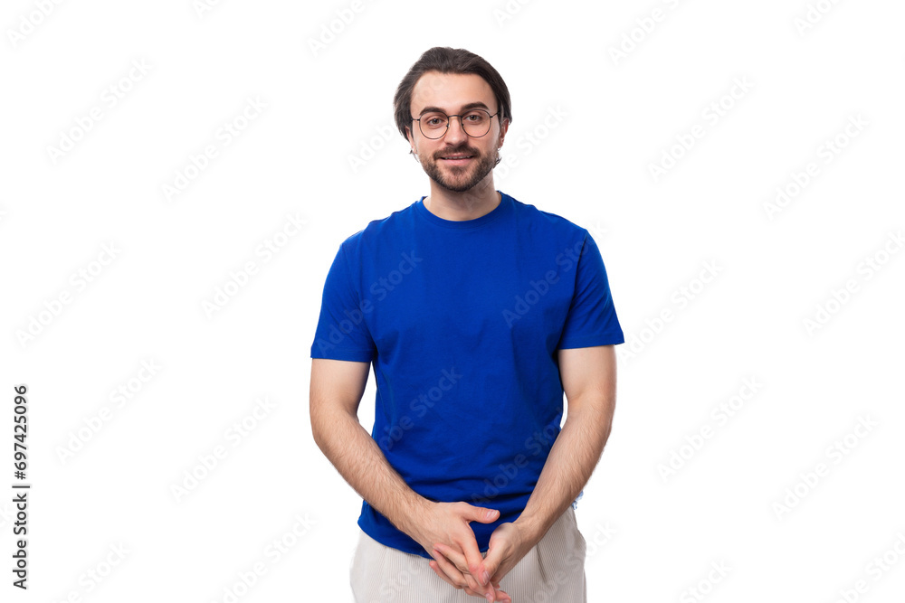 young confident brunette man with a beard dressed in a blue t-shirt on a studio white background young confident brunette man with a beard dressed in a blue t-shirt on a studio white background