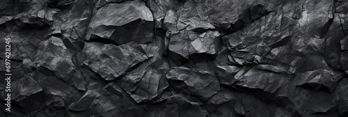 Panoramic black natural bold abstract rock background. Dark stone texture mountain close-up cracked banner ad design copy space