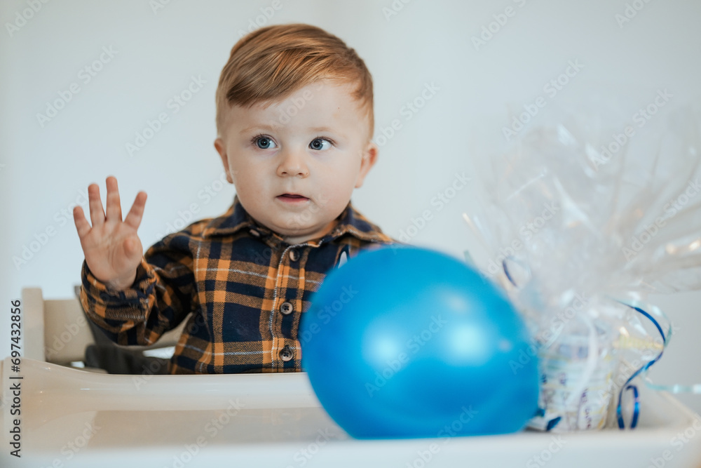 Toddler celebrating birthday playing with balloon Toddler celebrating birthday playing with balloon