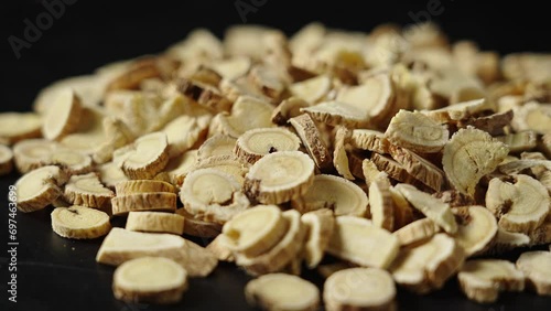 Chinese herb medicine Huangqi or Astragali Radix or Mongolian Milkvetch Root background. photo