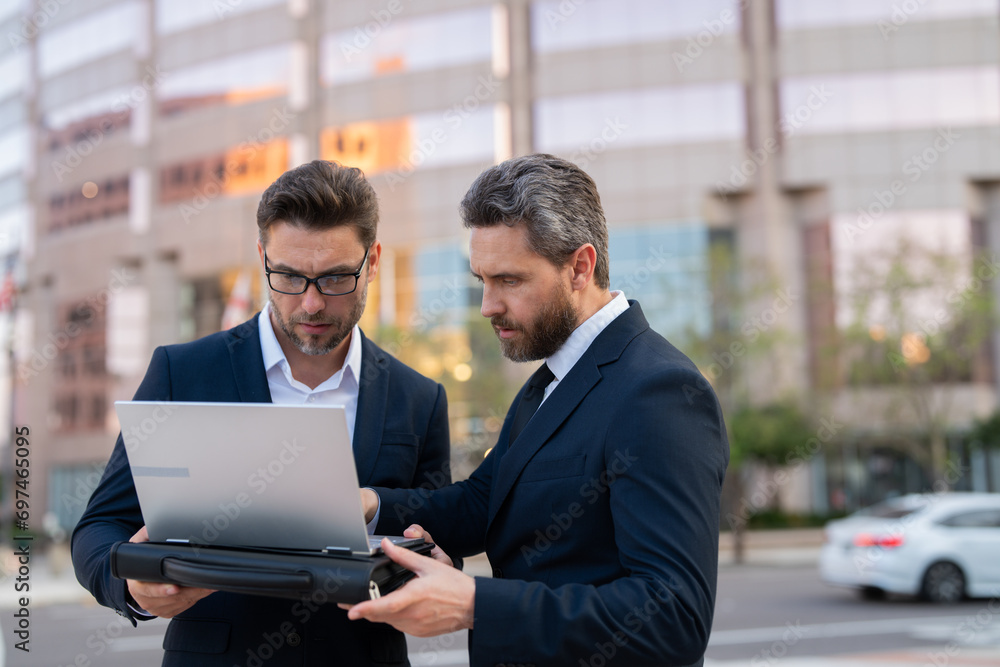 Two mature professional business executives working having conversation at meeting. Two happy professional business people team woman and man workers. Business people, teamwork and collaboration Two mature professional business executives working having conversation at meeting. Two happy professional business people team woman and man workers. Business people, teamwork and collaboration