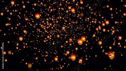 Golden color floating lantern. A large group of Chinese flying lanterns. Chinese sky lanterns floating in a dark night sky. Yee Peng Festival, Loy Krathong celebration. photo