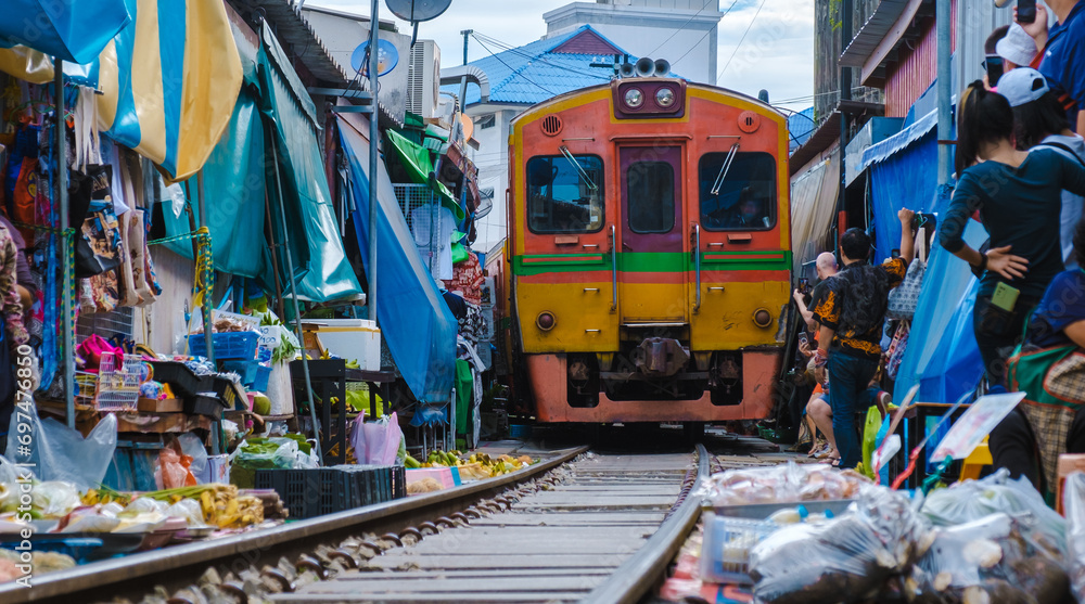 Fototapeta premium Maeklong Railway Market Thailand, Fresh Market on the Railroad Track of Mae Klong Train Station Bangkok a famous railway market in Thailand