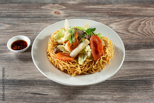 A view of a Vietnamese crispy noodle dish called mi xao gion hai san. photo