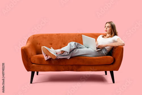 Young woman using laptop on...