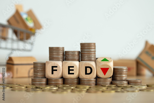 The Federal Reserve ( FED ) to control interest rates. Wooden blocks FED on coins stack. American economy and business. Federal Reserve Bank Interest rates rise policy. FED concept.Inflation photo