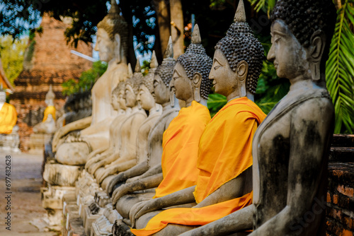 Ayutthaya, Thailand Wat Yai Chaimongkol with a Buddha statue outside the temple, Ayutthaya Historical Park covers the ruins of the old city of Ayutthaya, Phra Nakhon Si Ayutthaya Province, Thailand photo