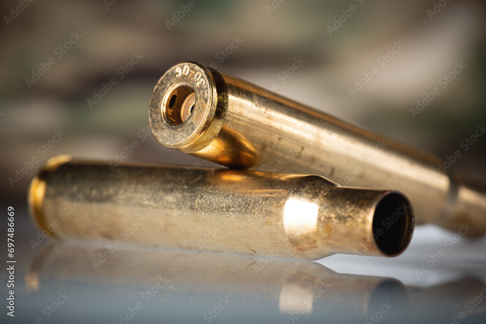 Demounted bullet shells on camouflage background Demounted bullet shells on camouflage background