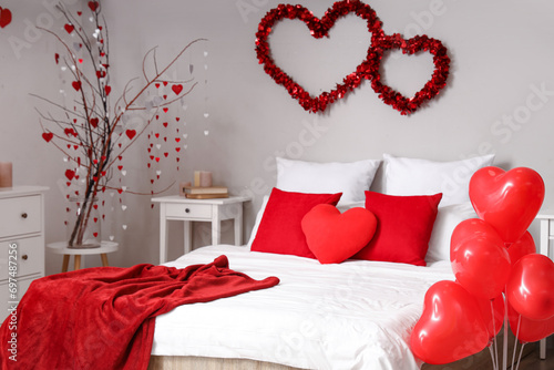 Big bed with pillows and ba...