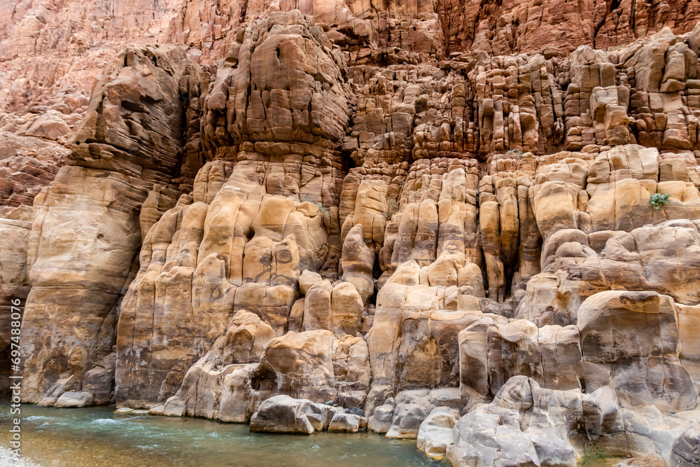Color  diversity of mountain rocks at the beginning of the tourist route in the Mujib River Canyon in Wadi Al Mujib in Jordan