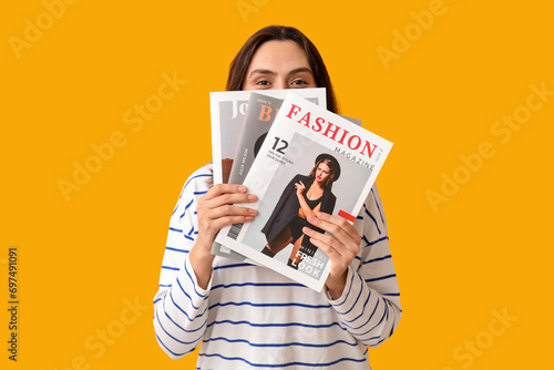 Young woman with magazines ...