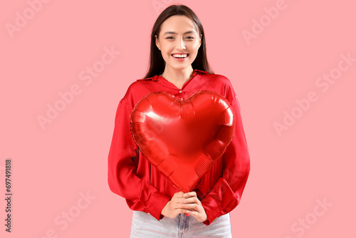 Smiling young woman holding...