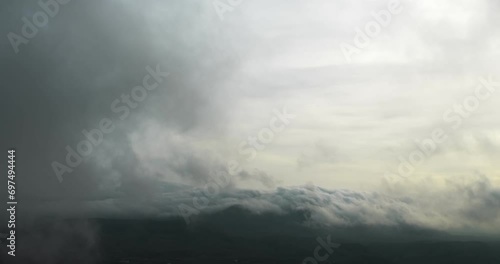 Top view of the clouds that lie on the hills and swirl. Strong wind. Autumn. Winter photo