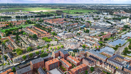 Aerial drone view of Gauda town cityscape from above, typical Dutch city skyline with canals and houses, Holland, Netherlands  © Iuliia Sokolovska