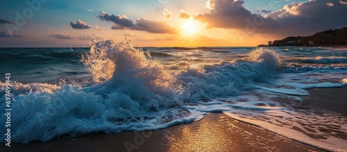 Gorgeous beach sunset with powerful waves photo
