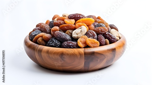 close shot of dried fruits and dates in a wooden bowl isolated in white background 