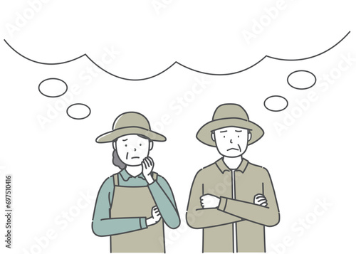 困った表情の農家の中高年夫婦