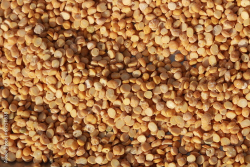 Heap of yellow split chick peas background. Also known as chana daal, chhana daal, dried chick pea in india photo