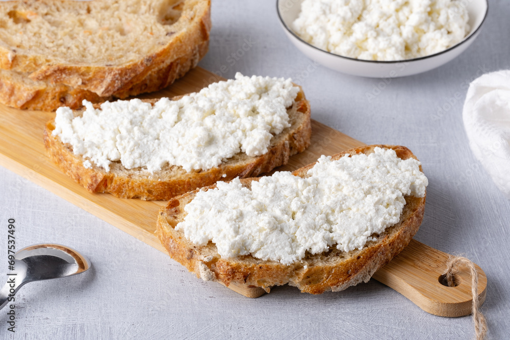 Bread with curd cheese on wooden board Bread with curd cheese on wooden board