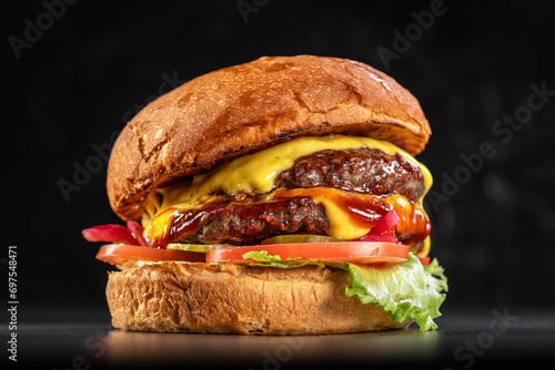 Delicious double cheeseburger close up on a black background. Delicious cheeseburger. sandwich fast food, amazing food photo