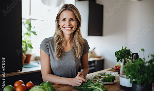 Beautiful young and healthy looking woman in the kitchen is preparing healthy food from tresh vegetables. Healthy lifestyle concept photo