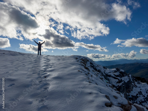 The happiness of the climber at the top of the snowy mountains