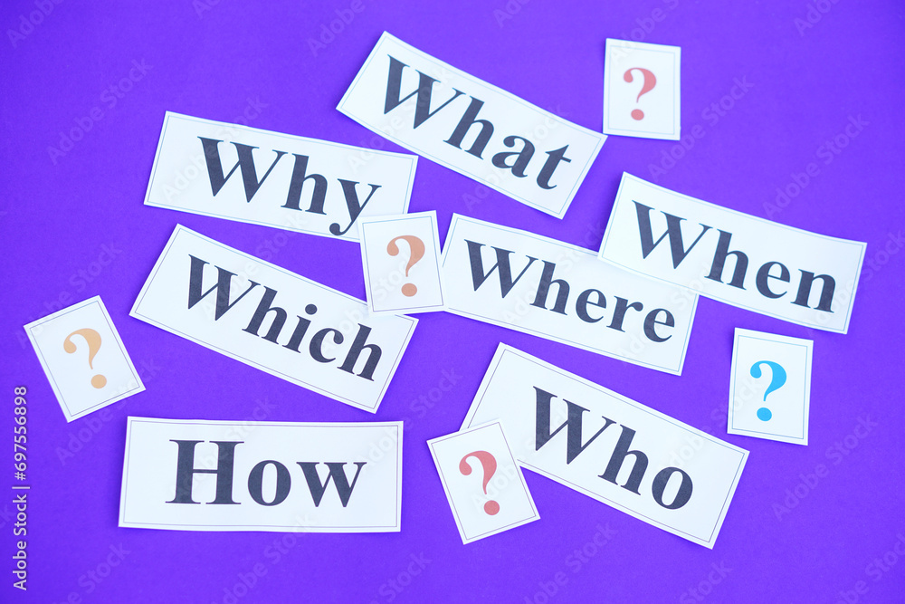 Paper cards with Whquestion words and question marks on purple