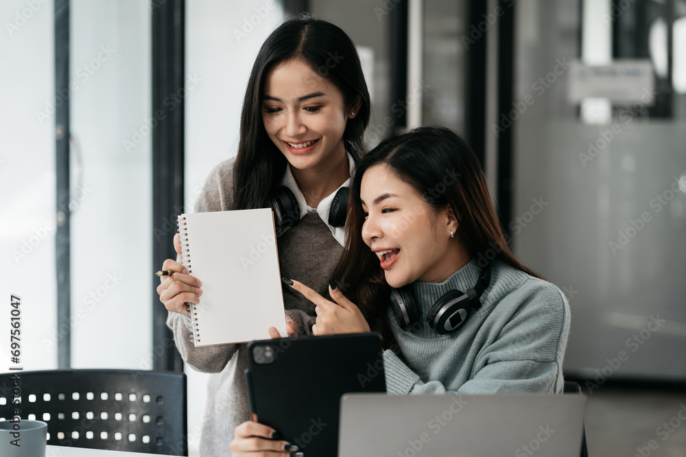 Office worker lifestyle people.Two happy women a laptop teleconference to brainstorm in a coworking space. Office worker lifestyle people.Two happy women a laptop teleconference to brainstorm in a coworking space.