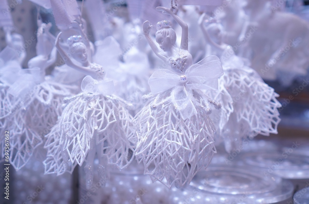 decorations for the Christmas tree in the form of figures of ballerinas in fishnet dresses on a shelf in a close-up in a hypermarket before Christmas decorations for the Christmas tree in the form of figures of ballerinas in fishnet dresses on a shelf in a close-up in a hypermarket before Christmas