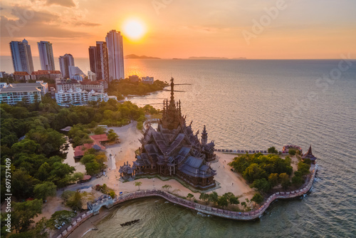 Skyline of Pattaya city at sunset with The Sanctuary of Truth wooden temple in Pattaya Thailand © Chirapriya