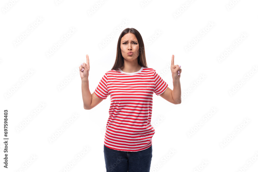 young satisfied cheerful brunette woman in a striped t-shirt actively gesturing on a white background with copy space young satisfied cheerful brunette woman in a striped t-shirt actively gesturing on a white background with copy space