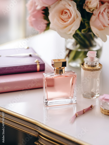 Pink perfume bottle and timeshare flowers on table