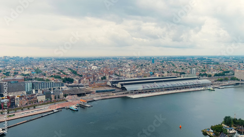 Amsterdam, Netherlands. Amsterdam Central Station. Amsterdam Centraal - The largest train station in the city, built in 1889. Bay IJ (Amsterdam), Aerial View © nikitamaykov