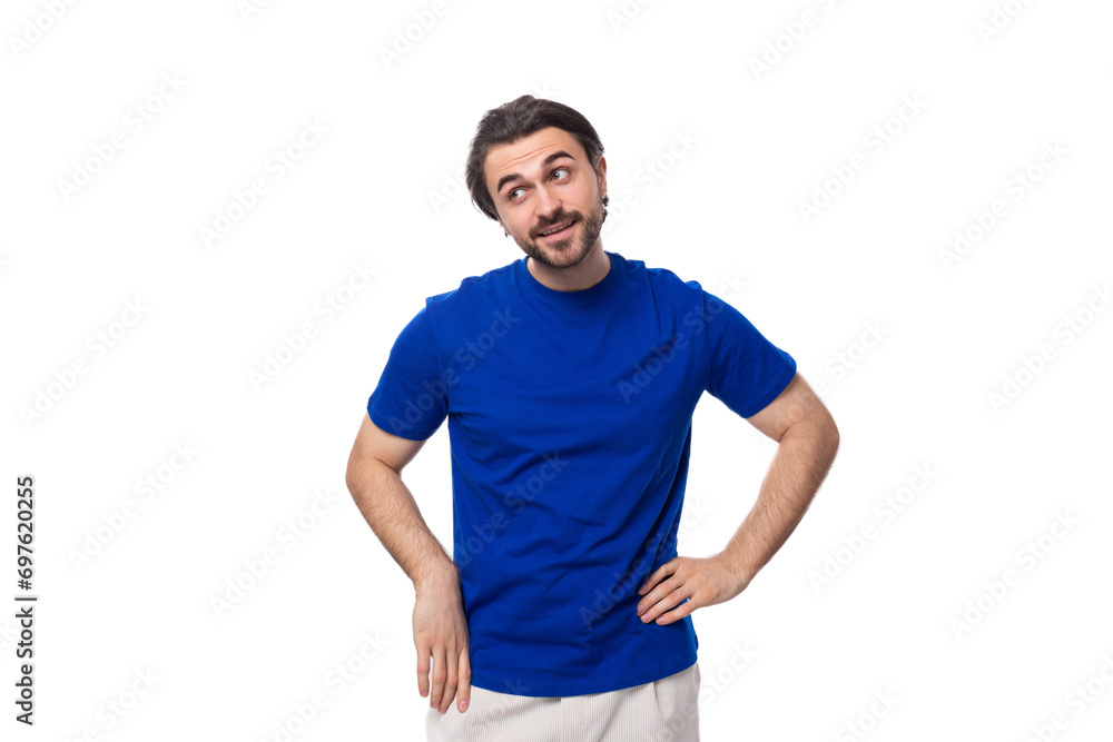 young brunette man with a beard dressed in a blue t-shirt thinks about a strategy and an idea on a white background young brunette man with a beard dressed in a blue t-shirt thinks about a strategy and an idea on a white background