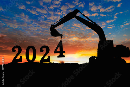 Concept happy new year 2024,crawler excavator silhouette with lift up bucket the number four .On sunrise backgrounds photo