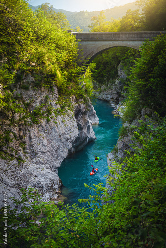 Kayakers exercising on the turquoise Soca river, near Kobarid, Slovenia