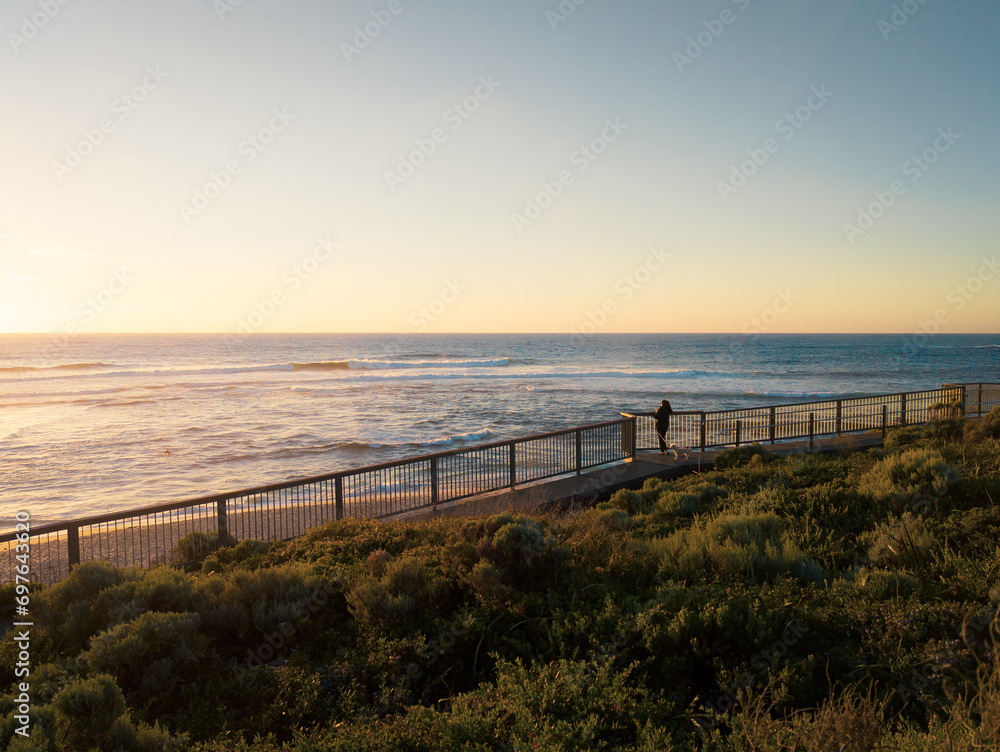 Woman Watches the Sunset by the Sea Woman Watches the Sunset by the Sea