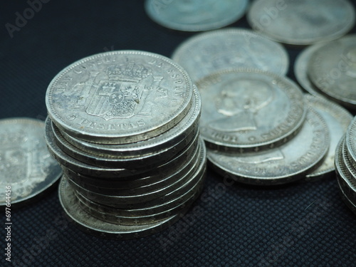 Five peseta coins, silver coins of Alfonso XIII on a black background photo