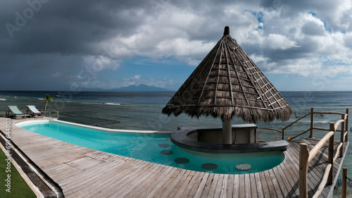 Panoramic view of swimming pool in a restaurant before the thunderstorm. Nusa Penida, Indonesia.