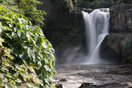 Long exposure shot of Tegenungan Waterfall on sunny day. Bali  Indonesia.