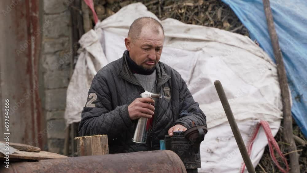 A man lights a device to create smoke A man lights a device to create smoke