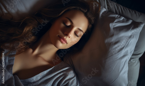 Overhead shot of a woman sleeping comfortably, bed advertisement material, promoting restful sleep © JQM