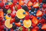 Fruit and berry background: strawberries, raspberries, blackberries, blueberries and citrus slices. Each berry looks delicious and fresh for a healthy diet or making a delicious dessert